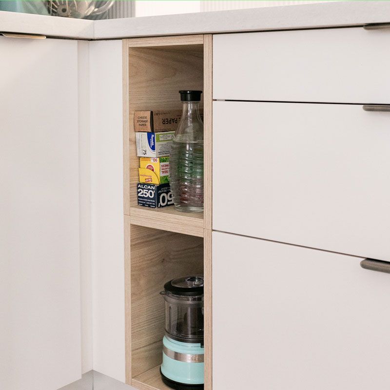 A shelf in a kitchen with a blender on it