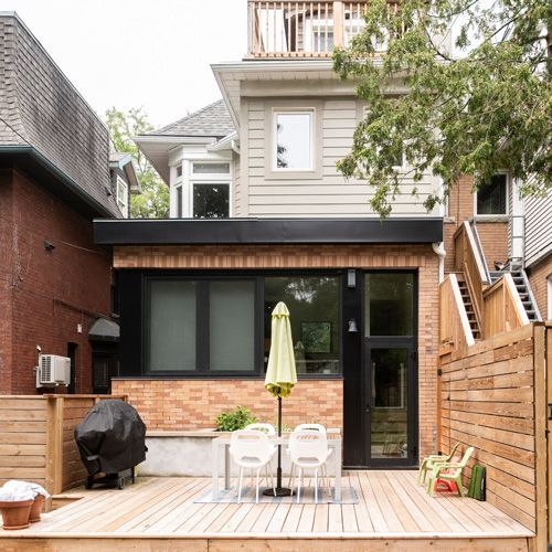A backyard with a table and chairs and an umbrella