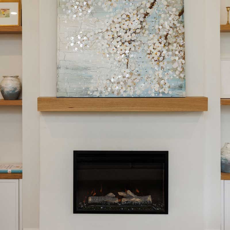 A fireplace with a painting on the mantle above it.