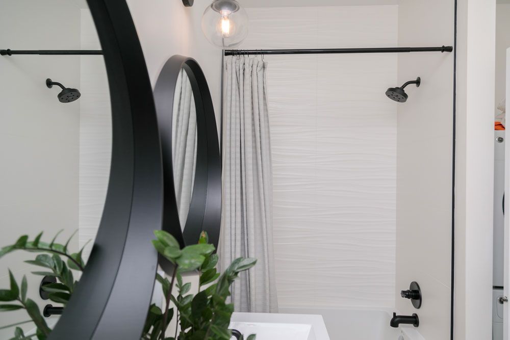 A bathroom remodel with a sink , shower , and mirror.