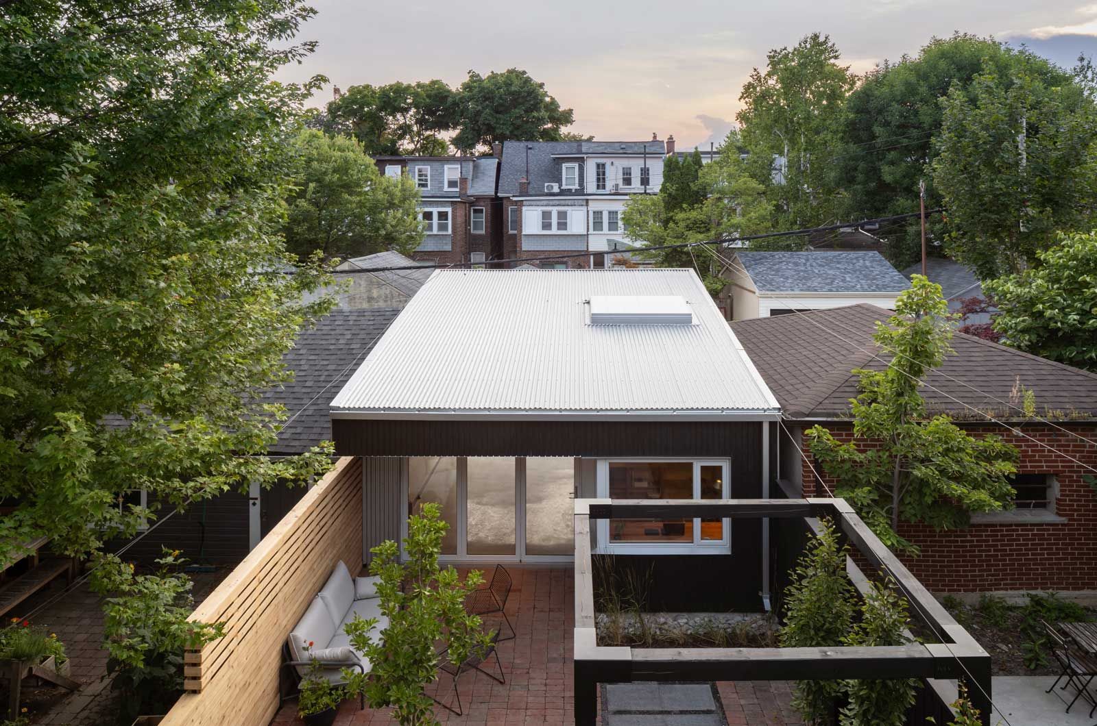 An aerial view of a house with a white roof