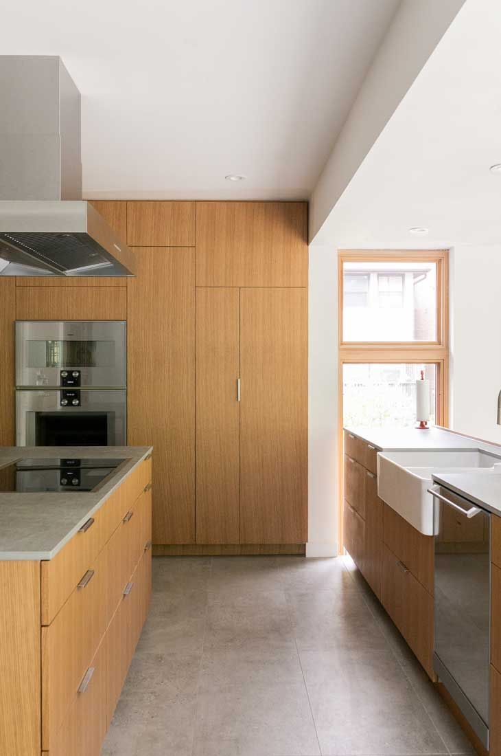 A kitchen with wooden cabinets and stainless steel appliances