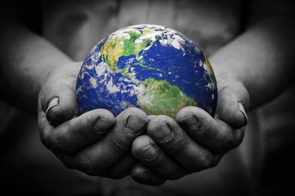 A person is holding a globe in their hands