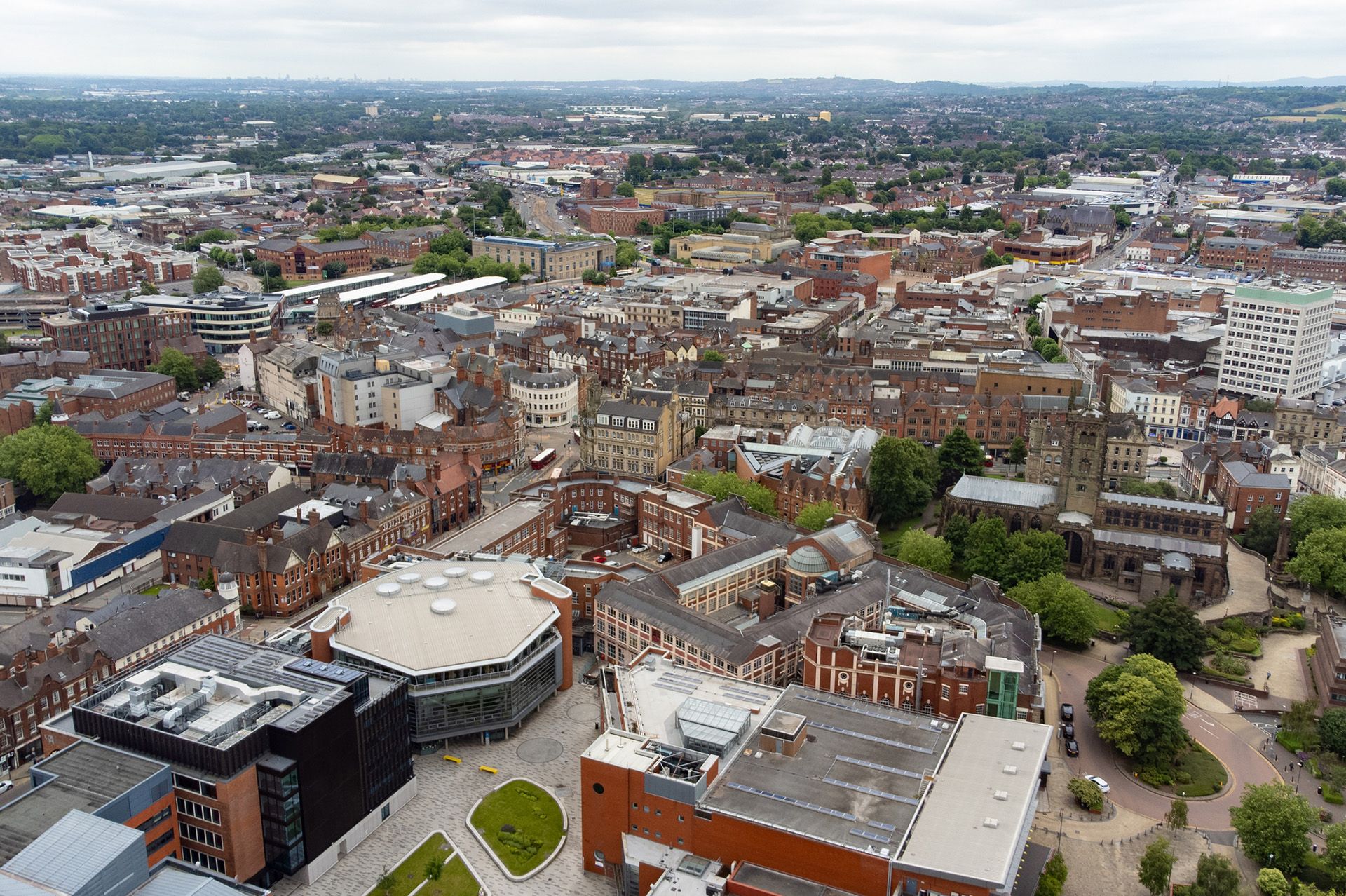 An aerial view of a city with lots of buildings and trees.