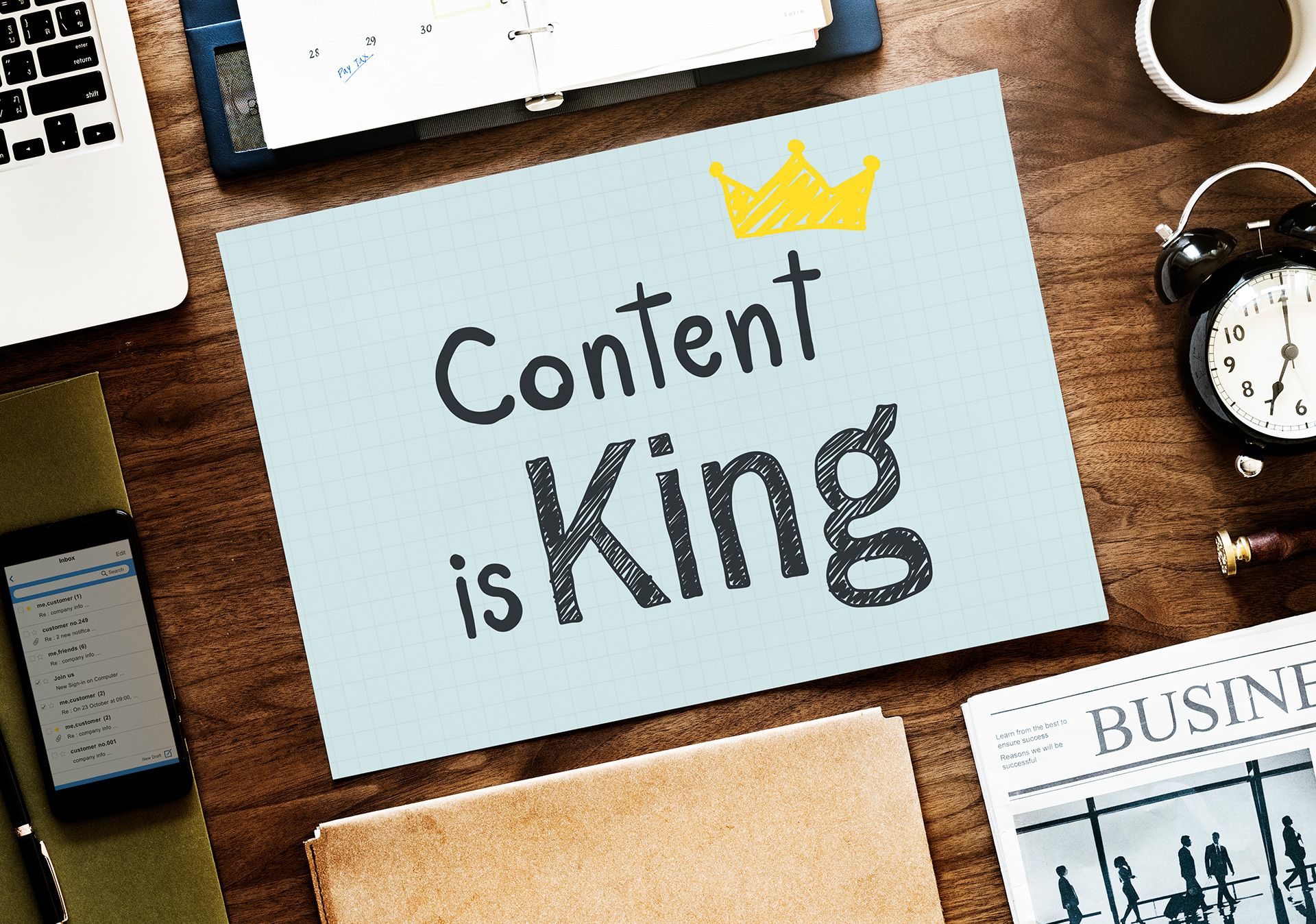 A wooden desk with a sign that says content is king