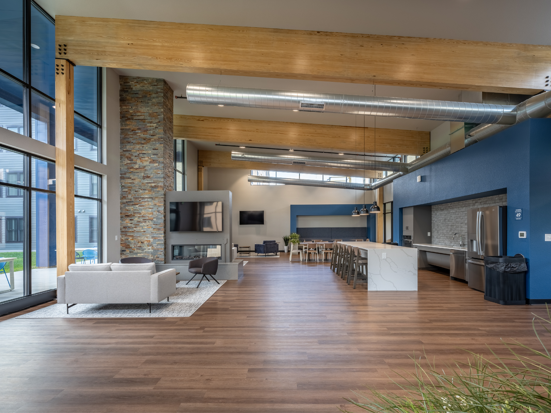 Community room with stone fireplace and large kitchen island