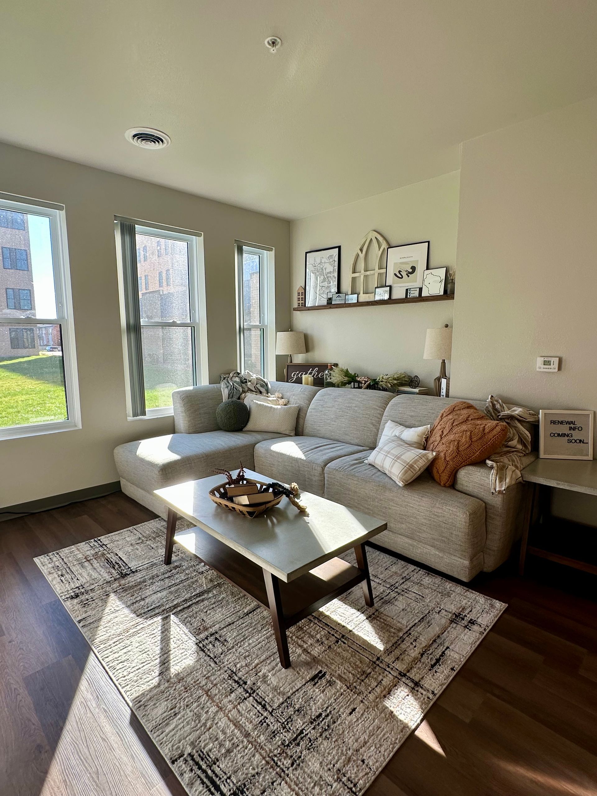 Apartment living room with couch and bright windows
