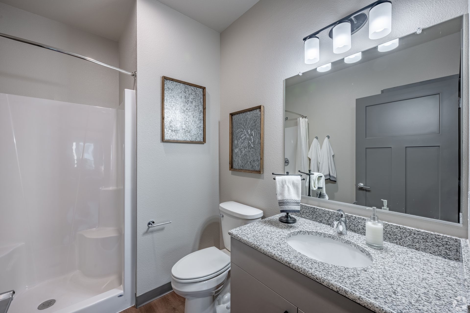 Bathroom with a standup shower and grey countertops on the sink