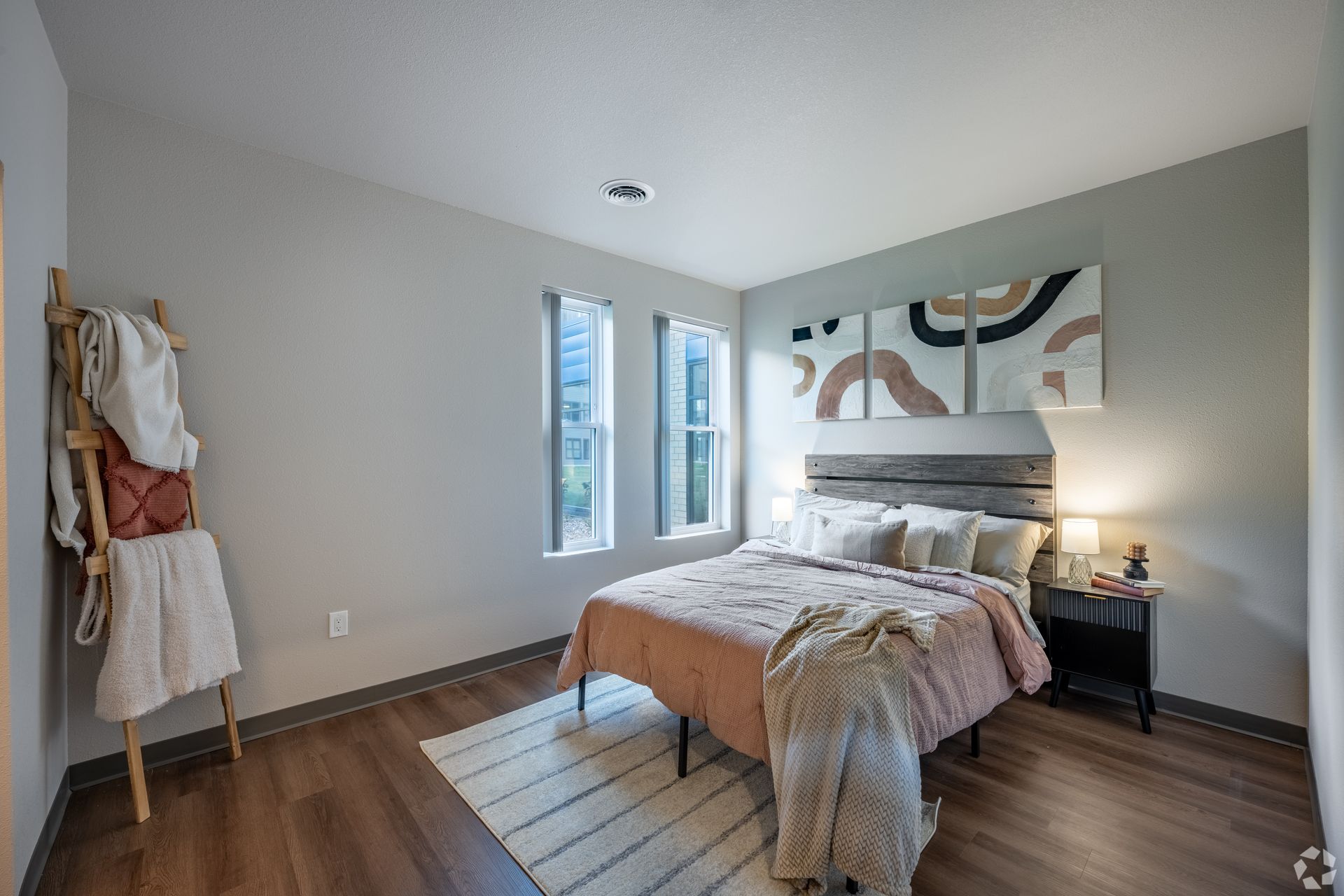 Bedroom with a window, a white area rug and art on the wall