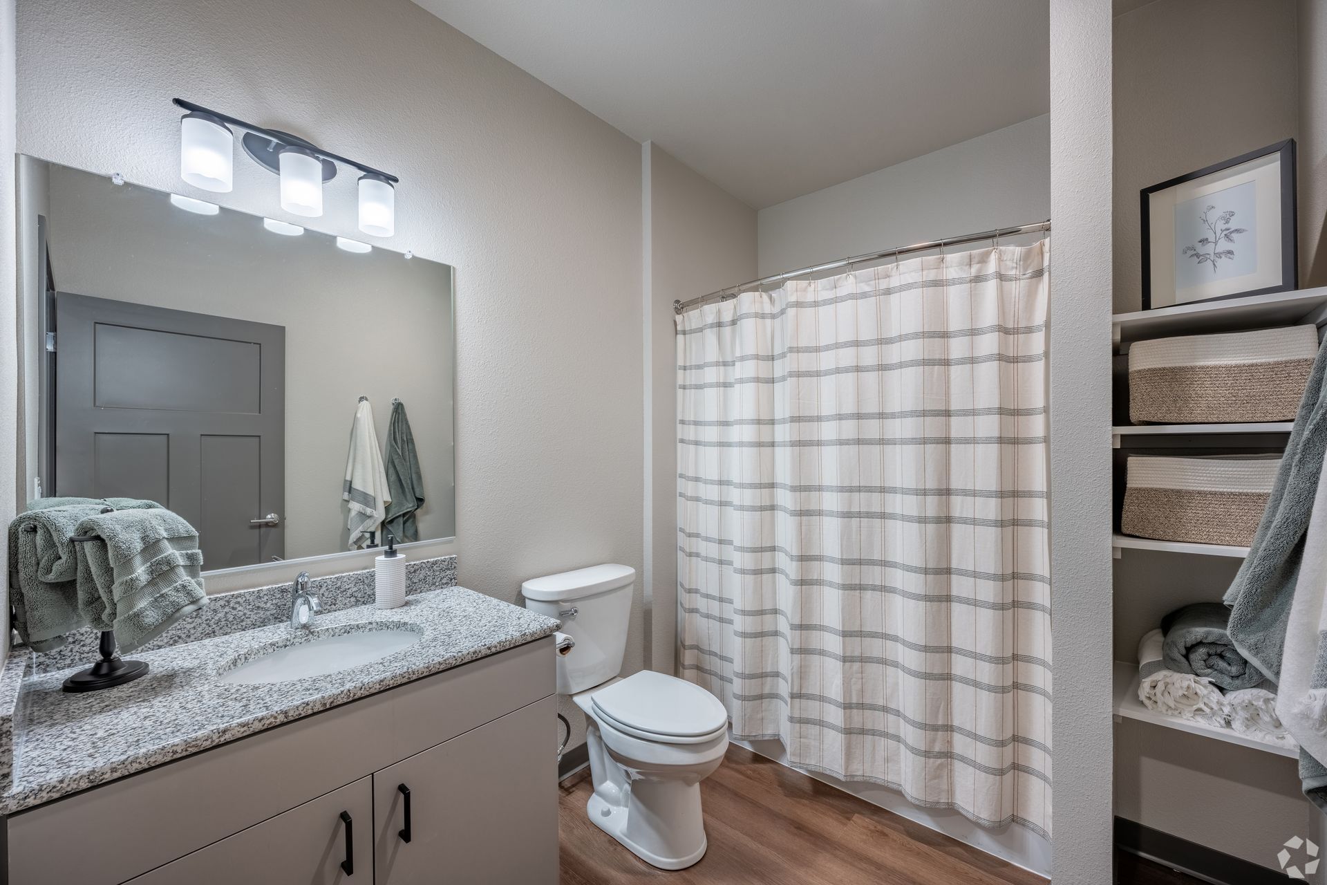 Full bathroom with grey countertops and a tub with a shower curtain