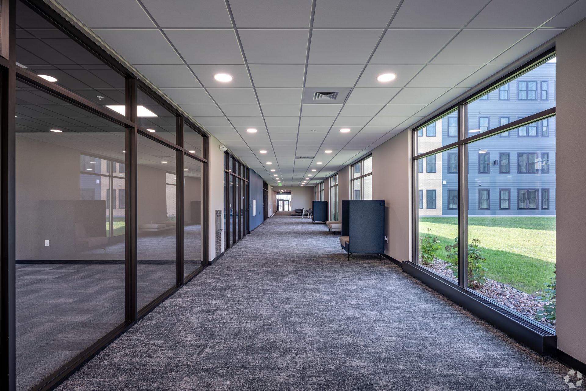Hallway with multiple windows to the outdoors and interior rooms