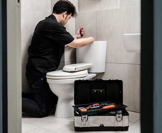 Man Fixing Bathroom — Virginia Beach, VA — Mike Bertolino & Co.