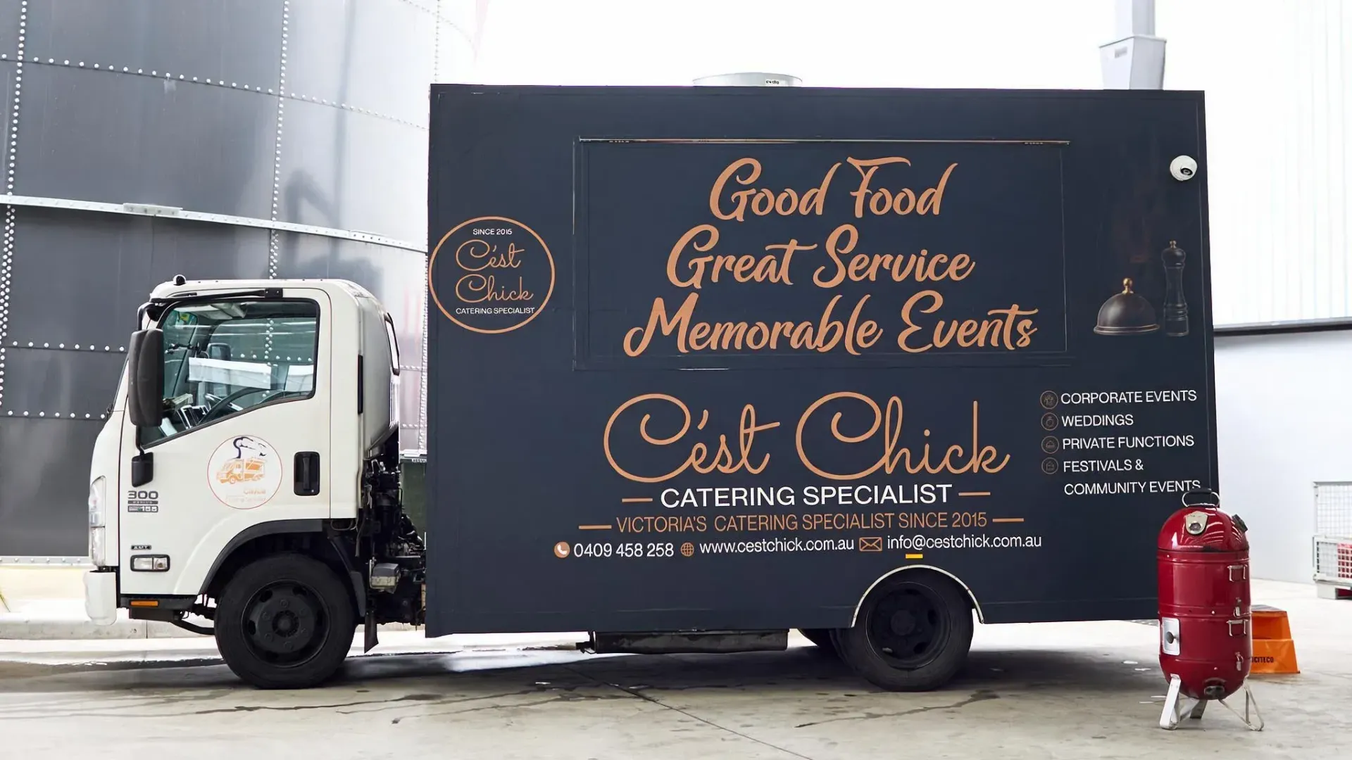 A couple standing in front of a food truck catering in Melbourne.