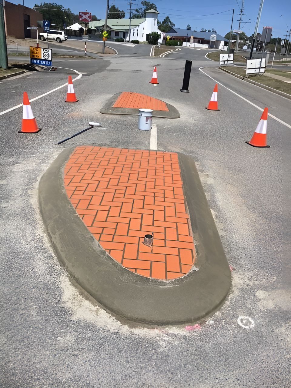 A Brick Walkway Is Being Built On The Side Of A Road  — Flash Concreting Pty Ltd In Nindaroo, QLD