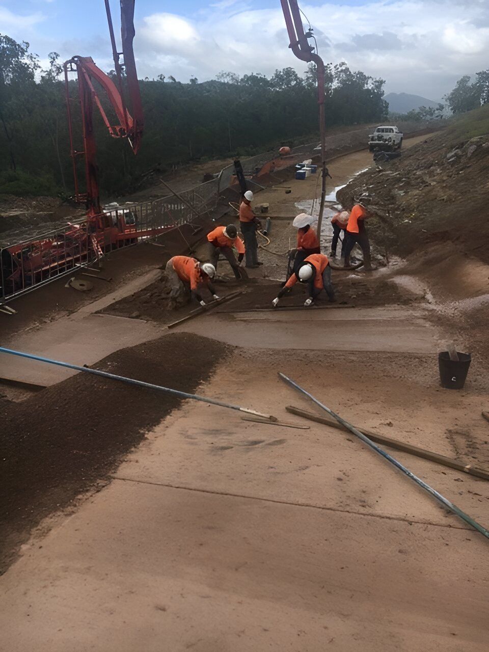 A Group Of Construction Workers Are Working On A Road — Flash Concreting Pty Ltd In Bowen, QLD