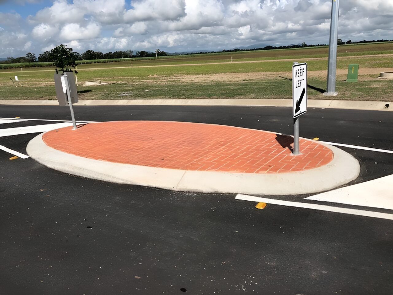 A Roundabout With A Sign On The Side Of It — Flash Concreting Pty Ltd In Nindaroo, QLD