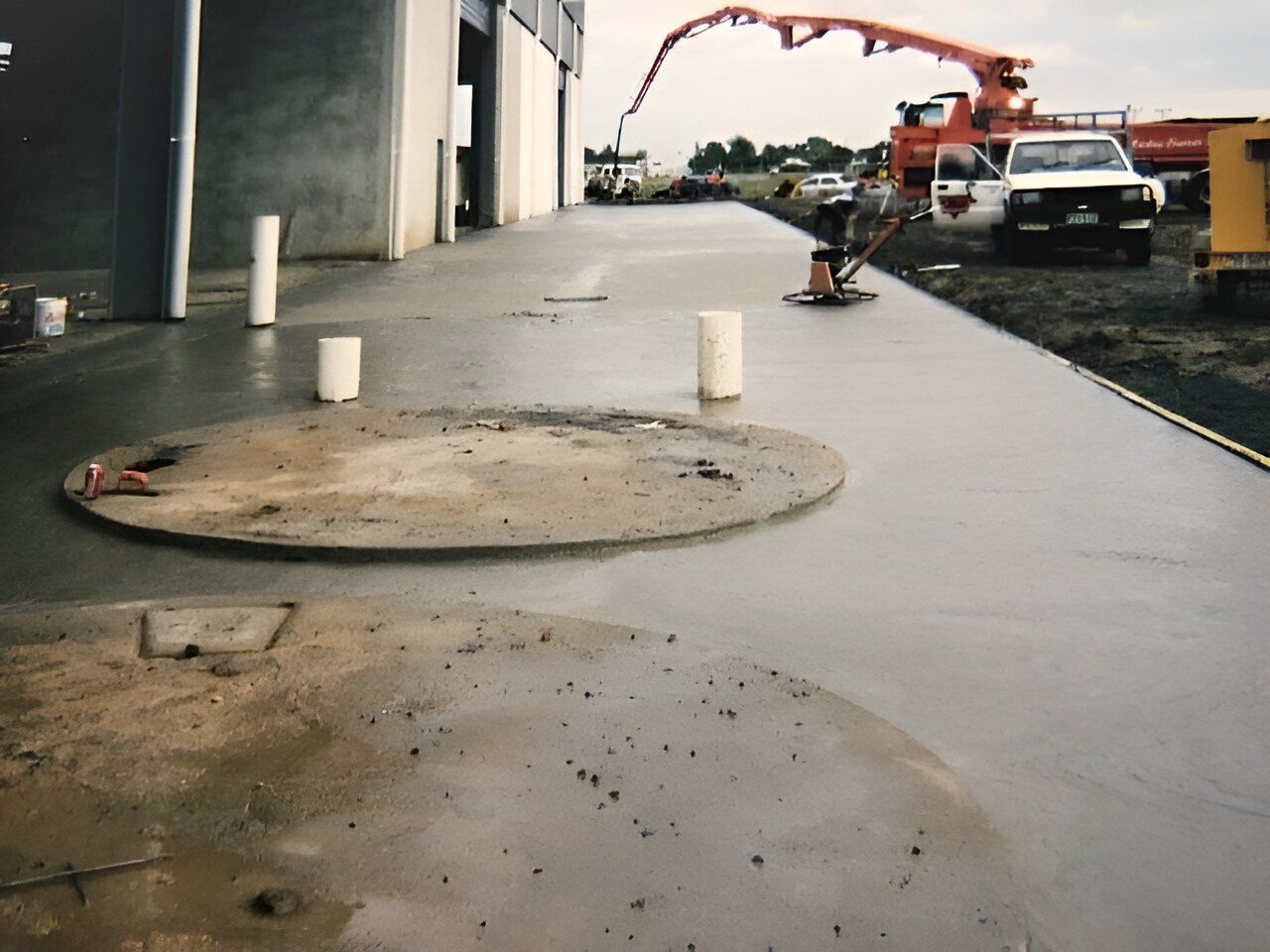 A Man Is Standing On A Concrete Surface — Flash Concreting Pty Ltd In Nindaroo, QLD