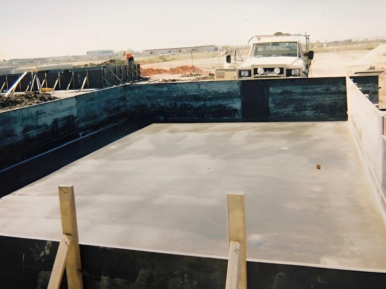 A White Truck Is Parked In Front Of A Large Concrete Pool — Flash Concreting Pty Ltd In Nindaroo, QLD