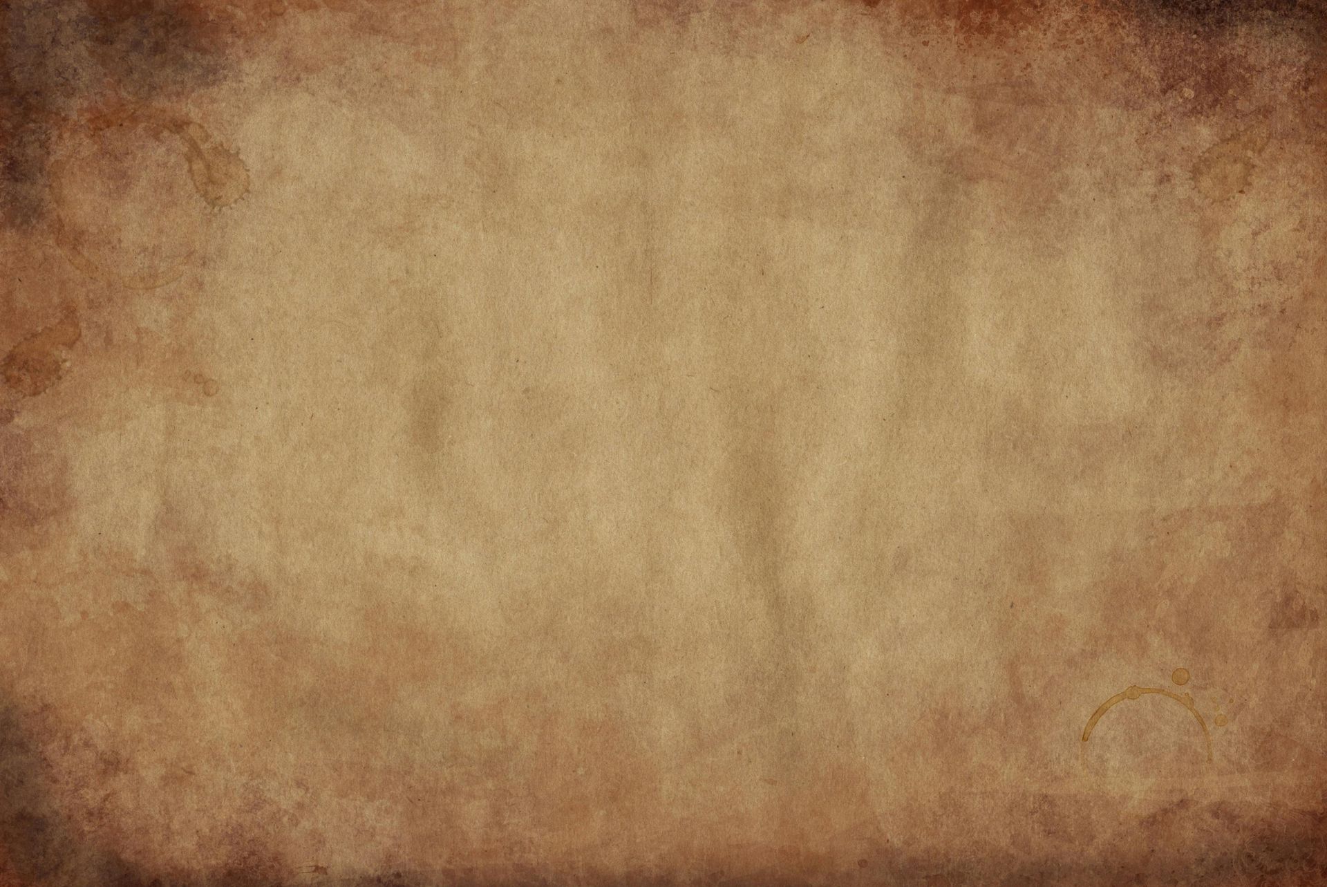 Torn and stained parchment paper, with browned edges and a tan center.