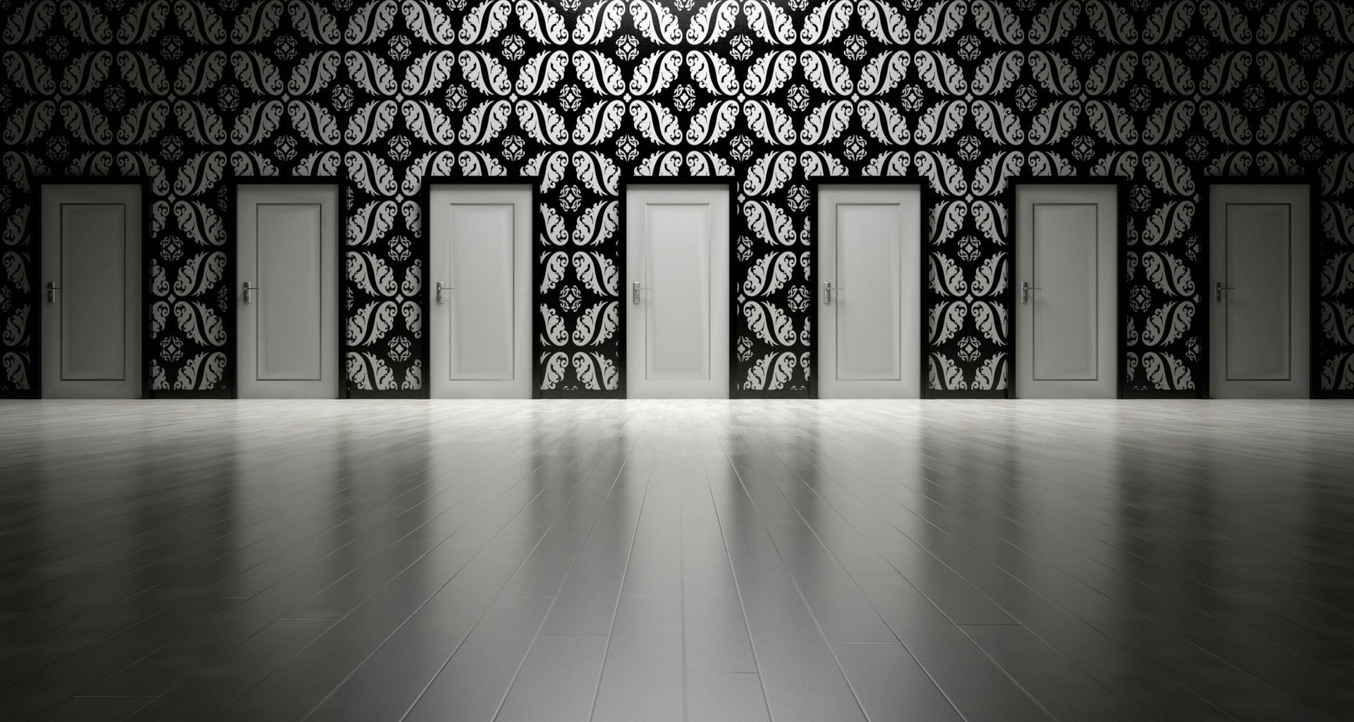 A row of doors in a room with a black and white pattern on the wall.