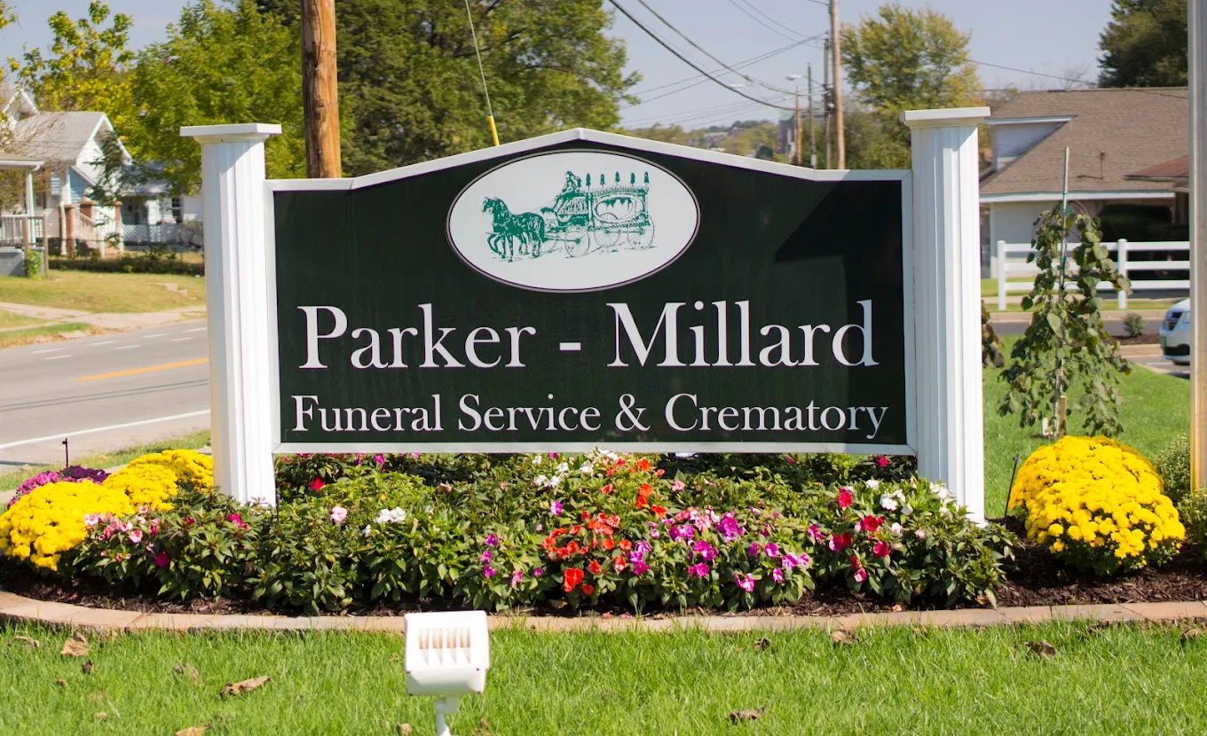 Parker-Millard Funeral Service & Crematory sign with flowers planted around it.