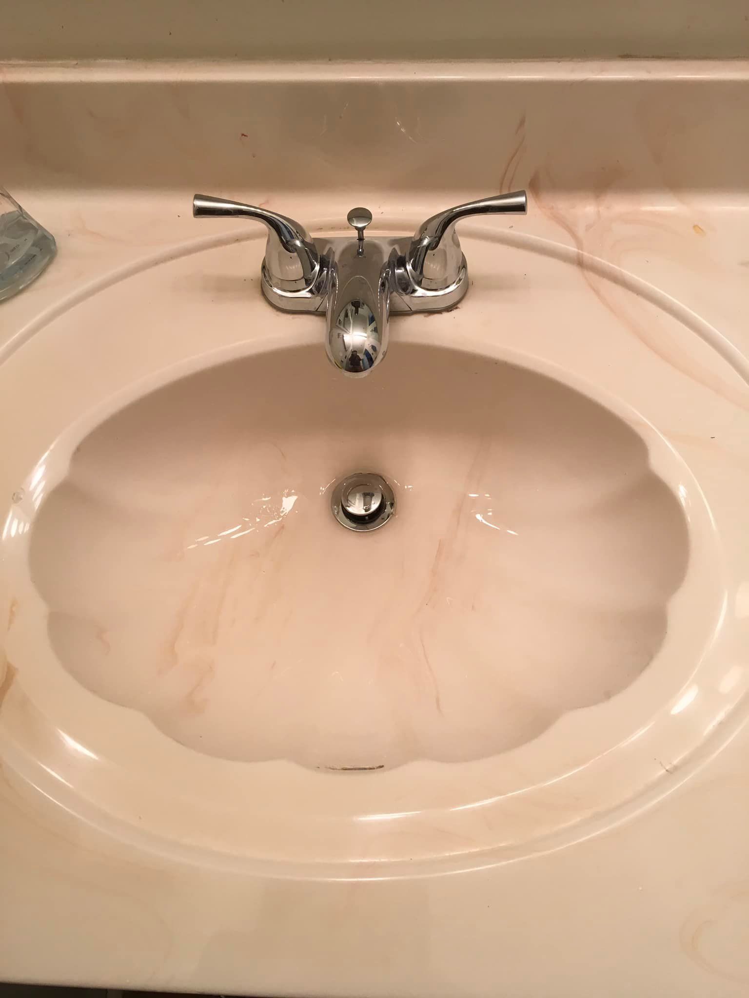 Aqua Plumbing Pros | A bathroom sink with a faucet and a drain
