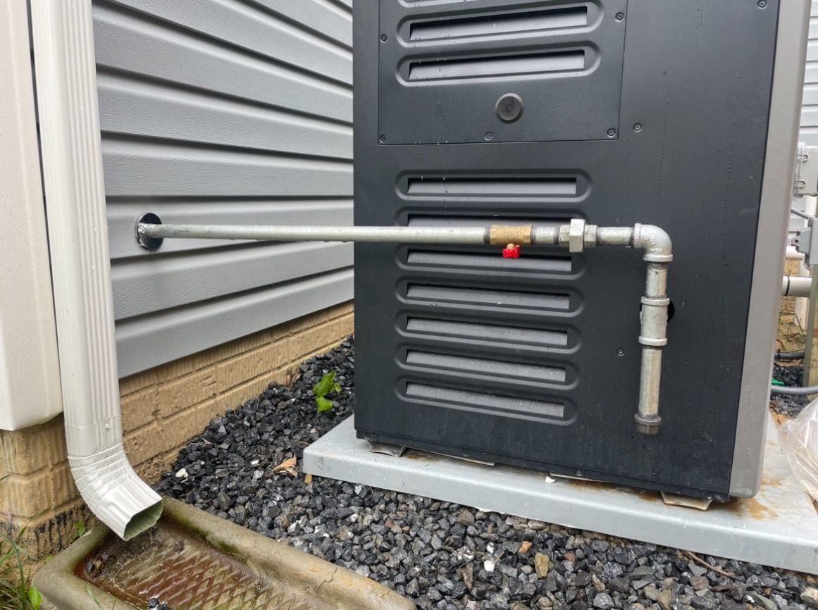 Aqua Plumbing Pros | There is a pipe attached to the side of a building.
