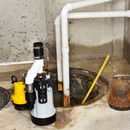 Aqua Plumbing Pros | A yellow pump sits next to a white pipe
