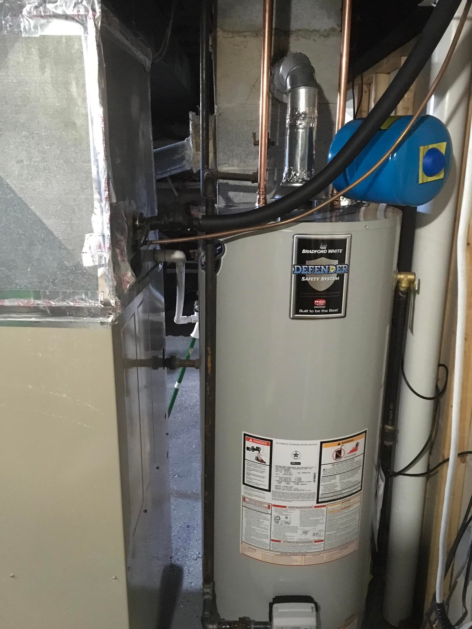 Aqua Plumbing Pros | A water heater is sitting in the corner of a room.