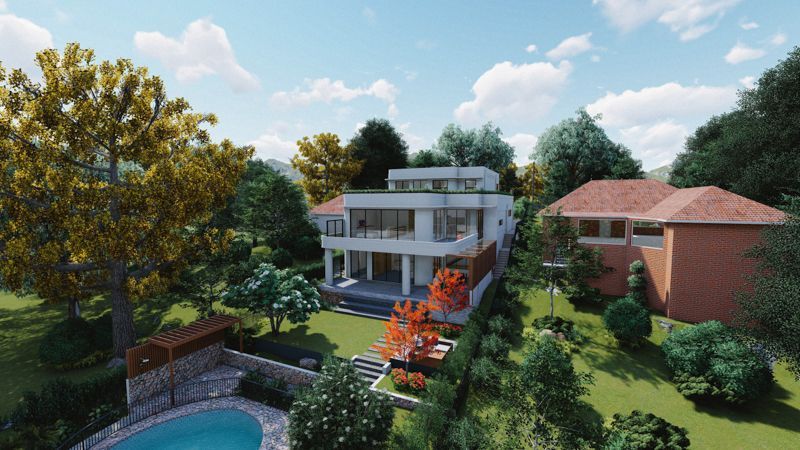 An aerial view of a house with a pool in the backyard surrounded by trees.