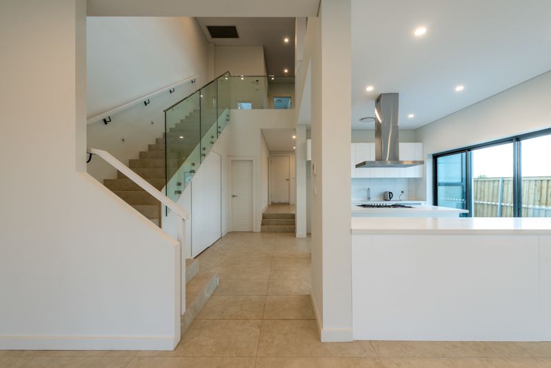 A kitchen with a staircase leading up to the second floor