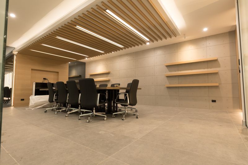 A conference room with a table and chairs in it