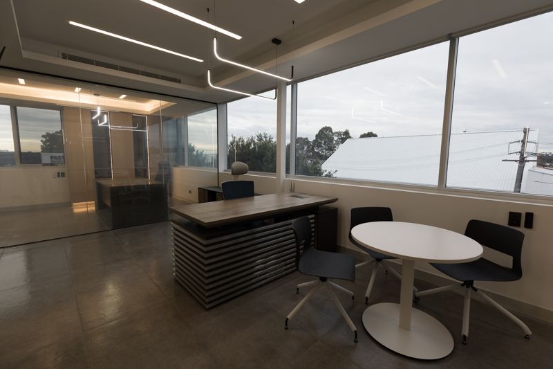 There is a table and chairs in the middle of the room.