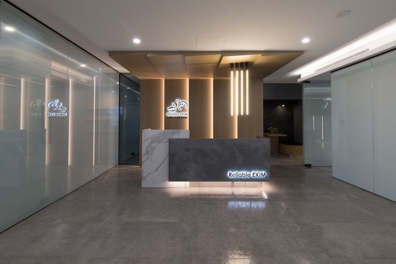 A lobby with a marble counter and a glass wall.