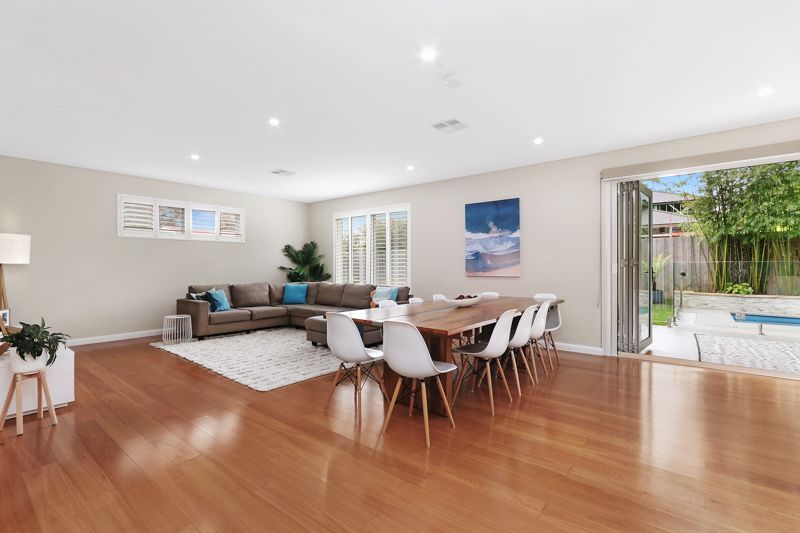 A living room with a dining table and chairs and a couch.