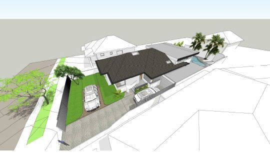 An aerial view of a house with a car parked in front of it
