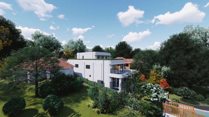 An aerial view of a house surrounded by trees and grass.