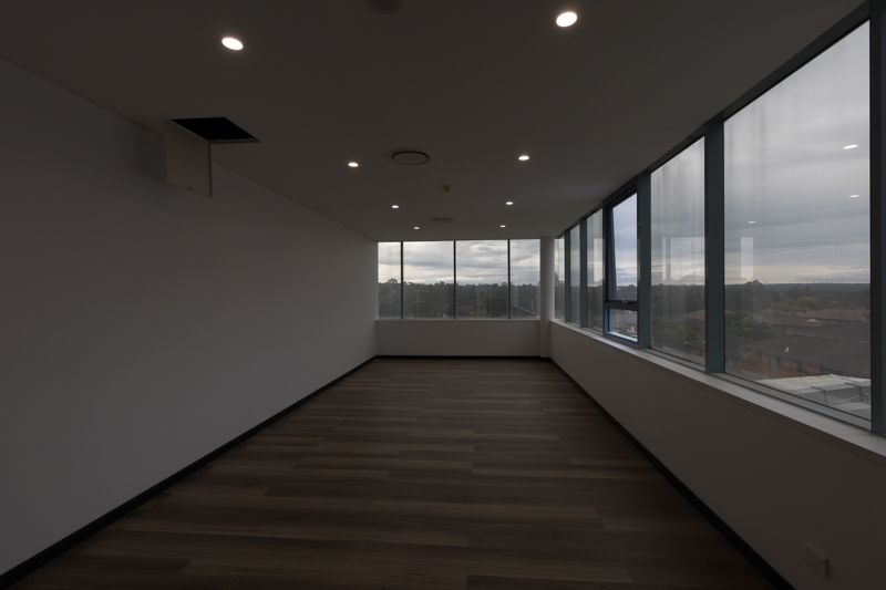A large empty room with a lot of windows