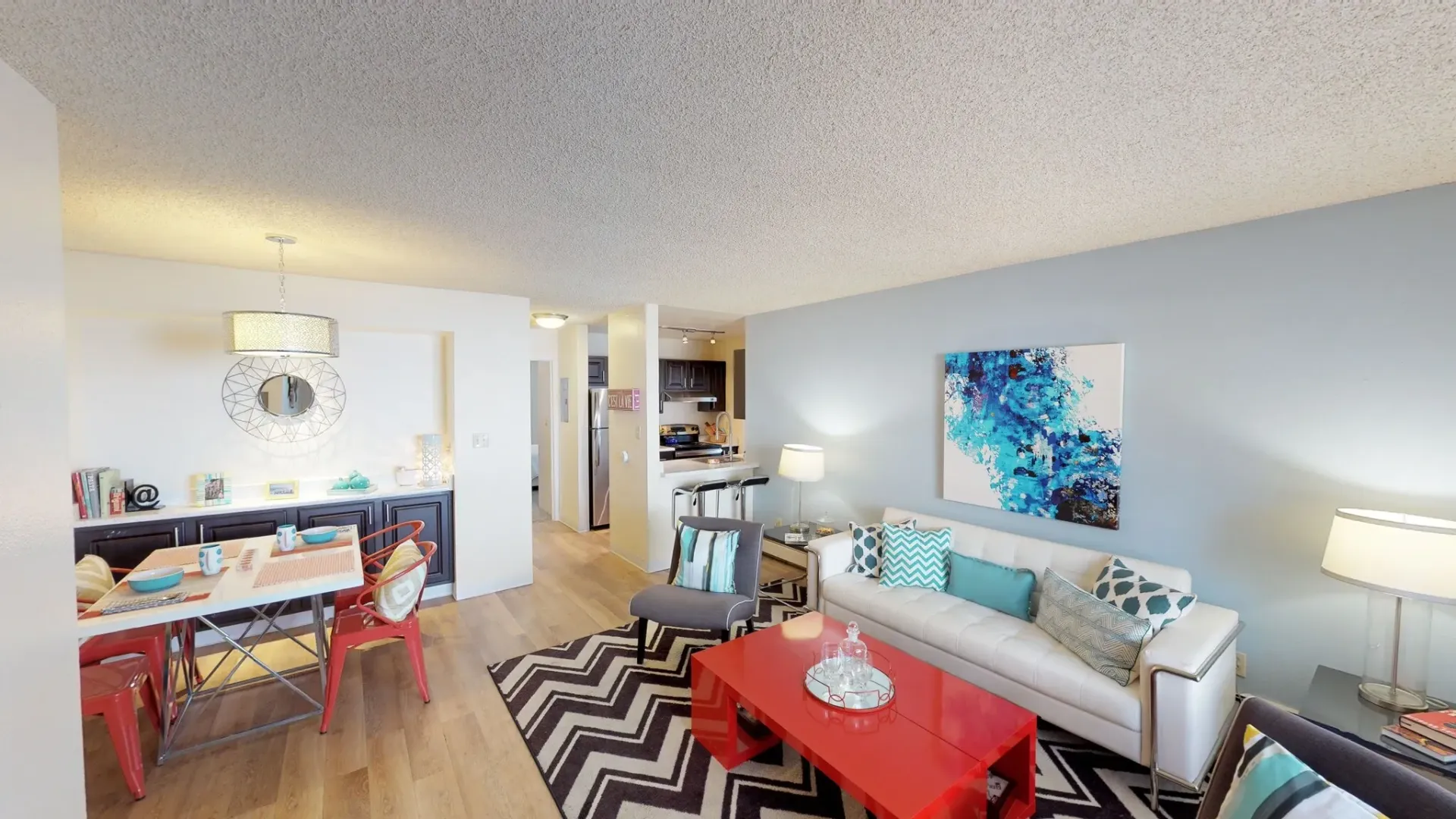 Stylish living and dining area with modern furniture and decor.