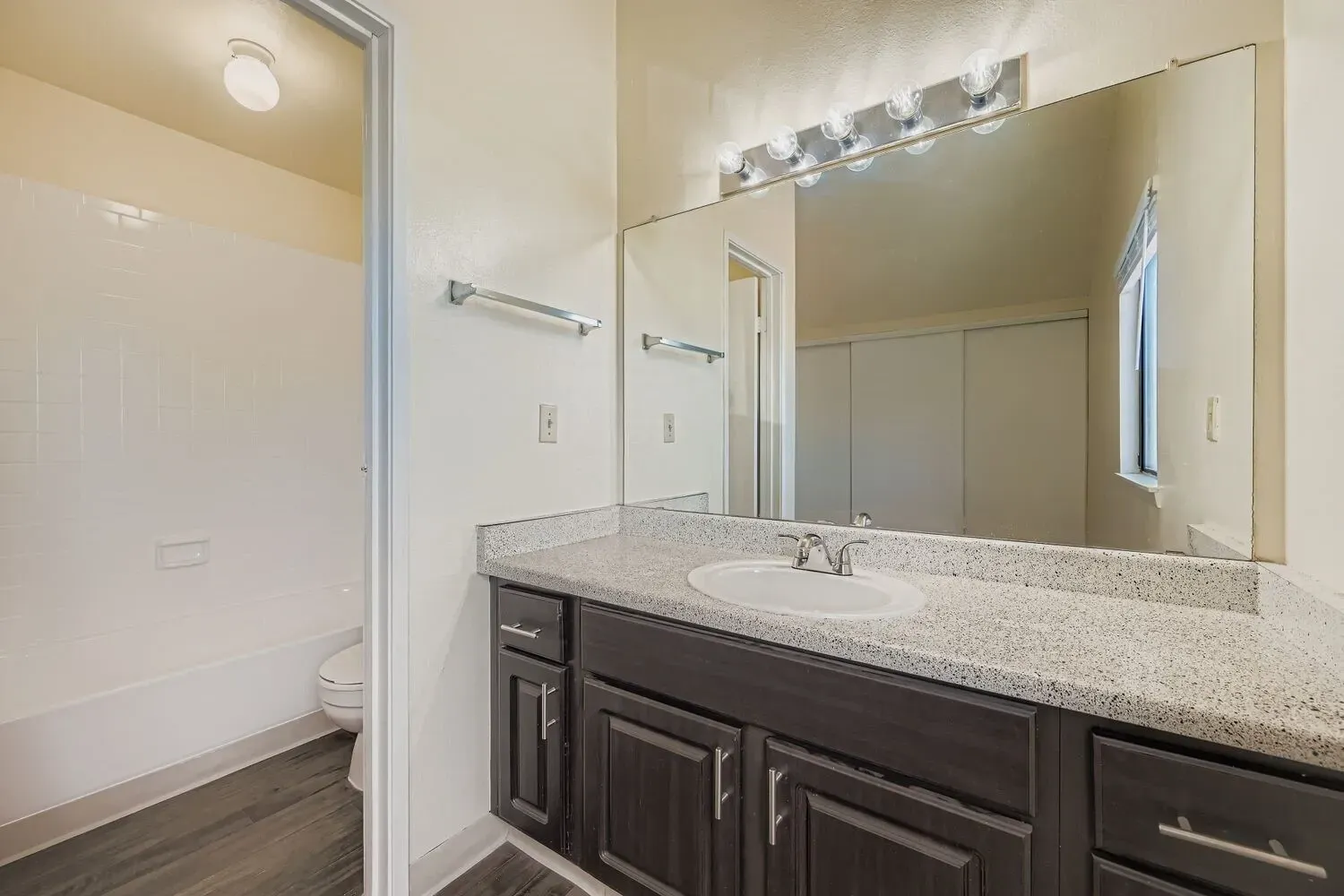 Bathroom with vanity, sink, and bathtub.