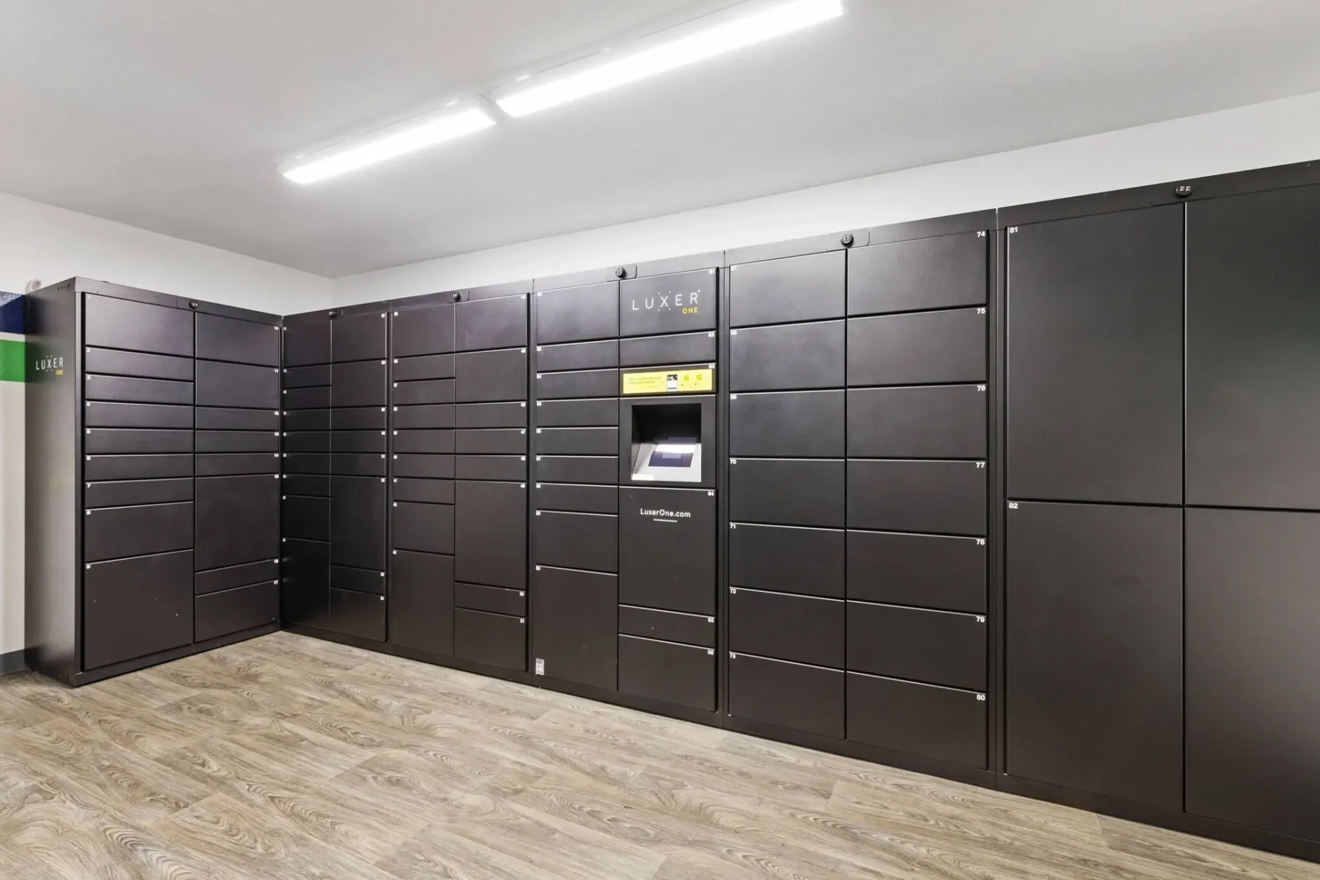 Luxer One package lockers in a community room.
