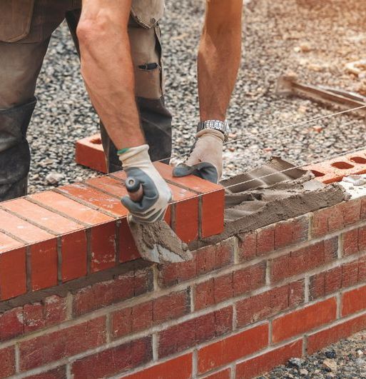 A brick wall is being installed by a brick mason from the masonry contractor Wichita Masonry in the Rockhurst area of Wichita, Kansas.