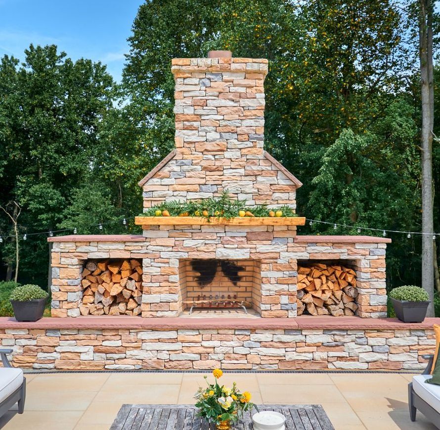 As stone fireplace and chimney have been installed by a masonry contractor in Wichita, Kansas.