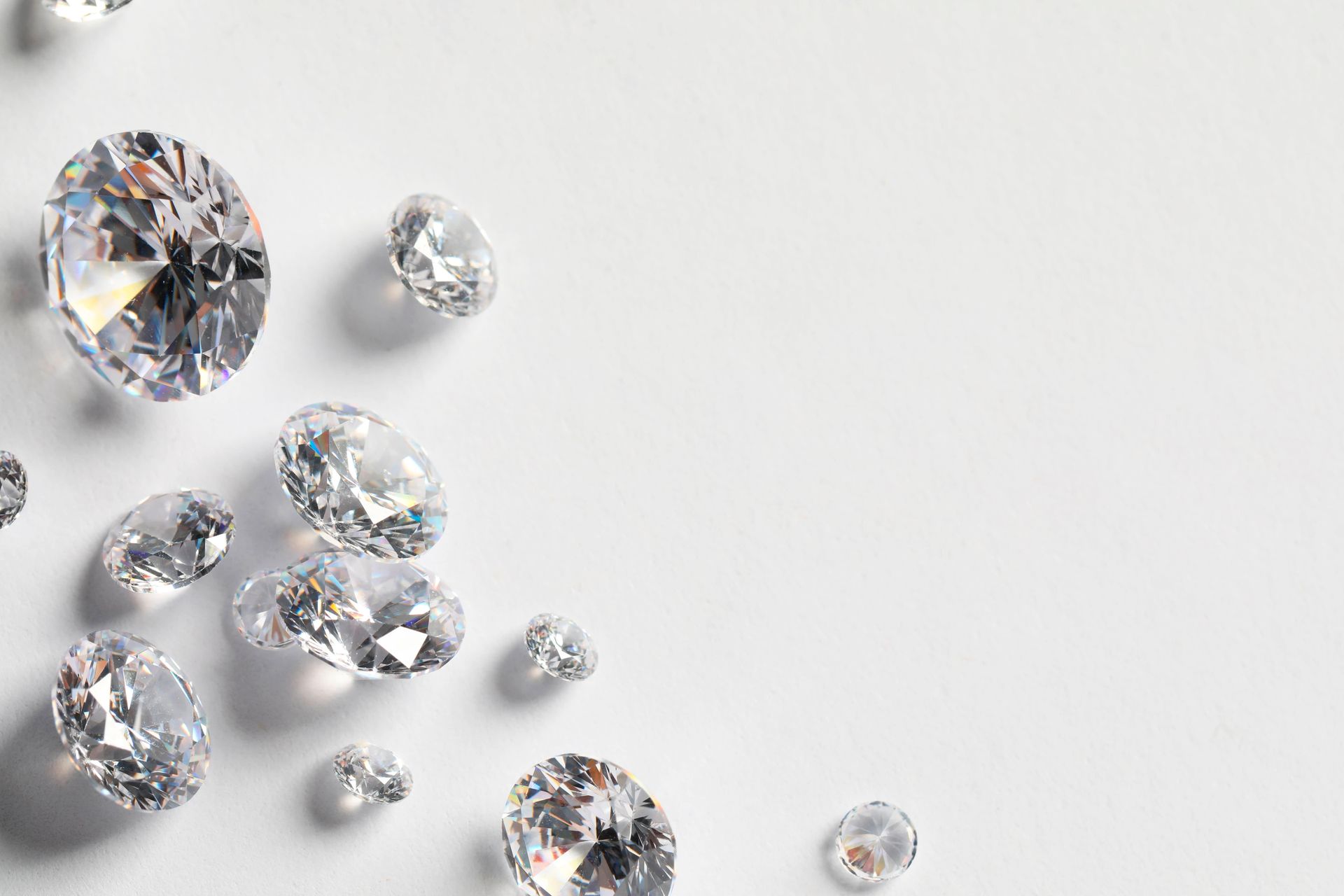 Scattered clear diamonds on a light gray surface