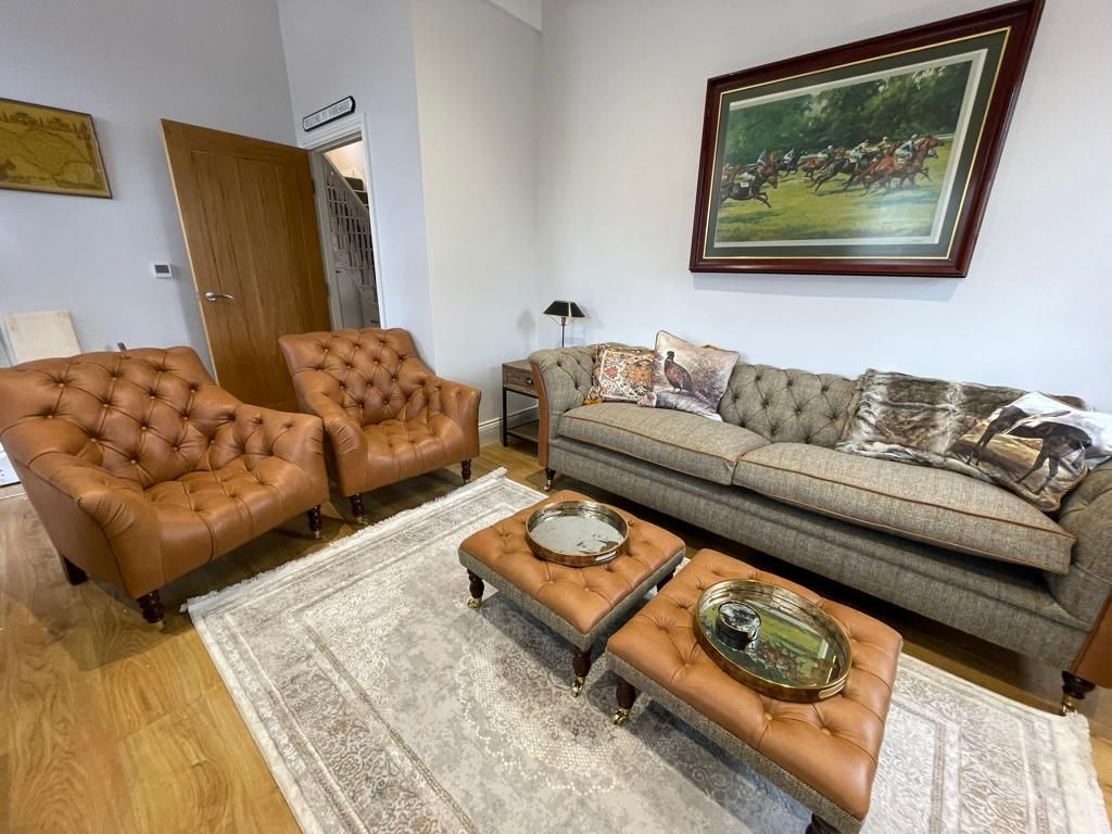 Mulbery House - Living room with beautiful Chesterfield Sofa and leather tub chairs