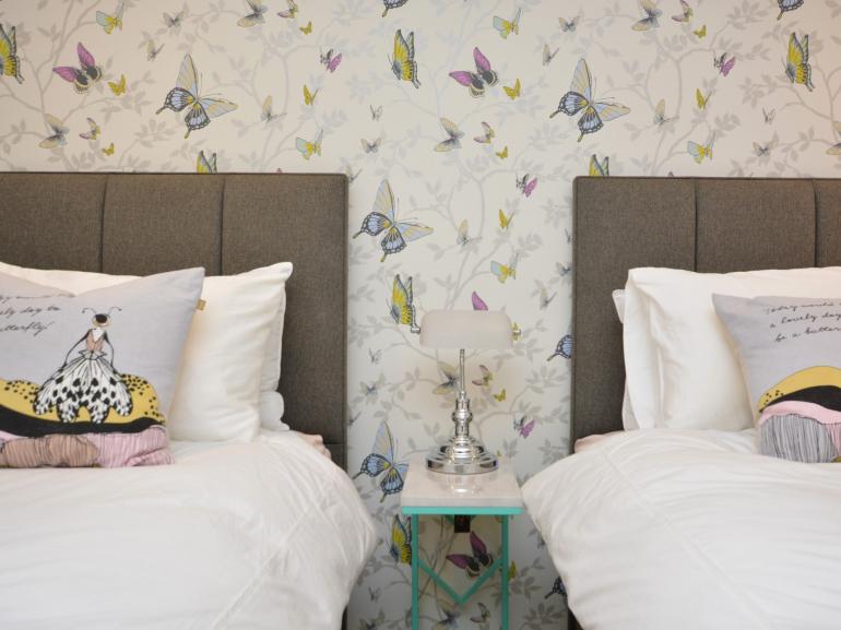 Lovely twin bedroom and butterfly wallpaper