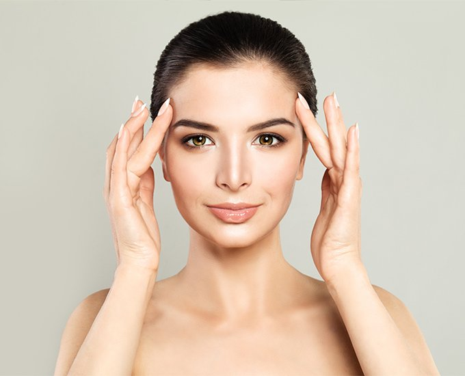 smiling woman with customized treatment plan from Dr. Gina Mantor