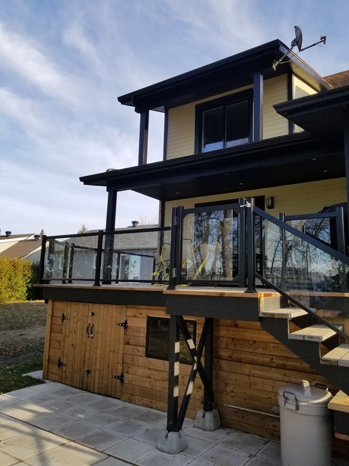 Une maison avec une grande terrasse et des escaliers qui y mènent