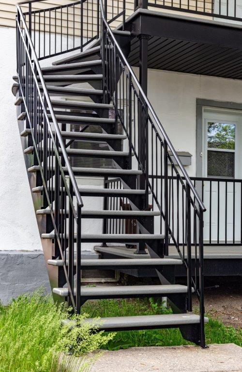 Un ensemble d'escaliers menant à un balcon sur le côté d'un bâtiment.