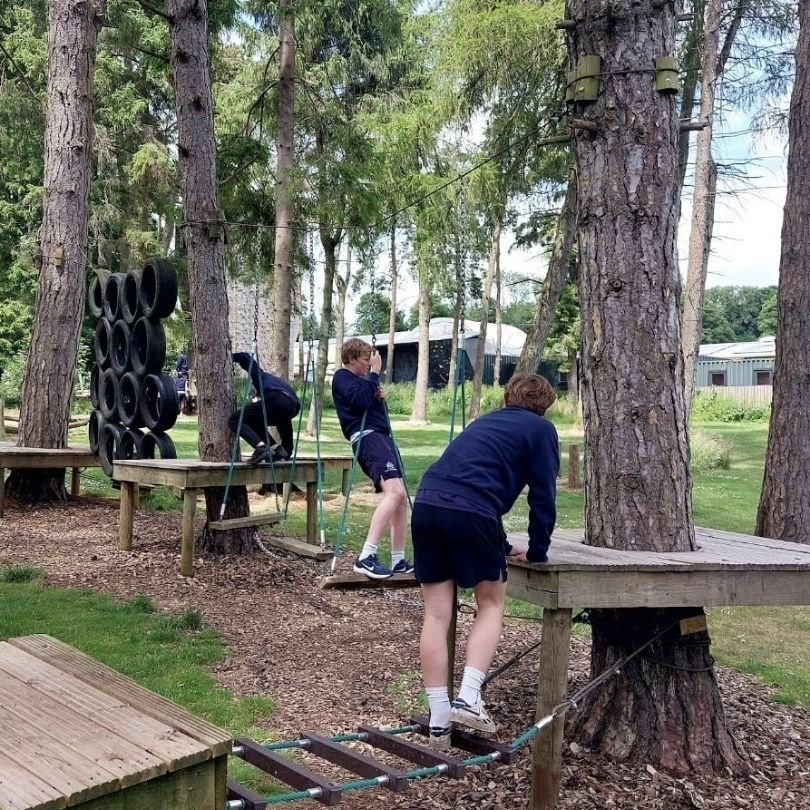 A group of people are climbing a climbing wall.